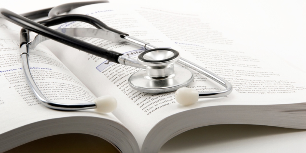 A stethoscope on top of a textbook