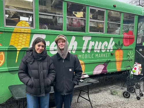 Two students volunteering for the Christian Life Community.