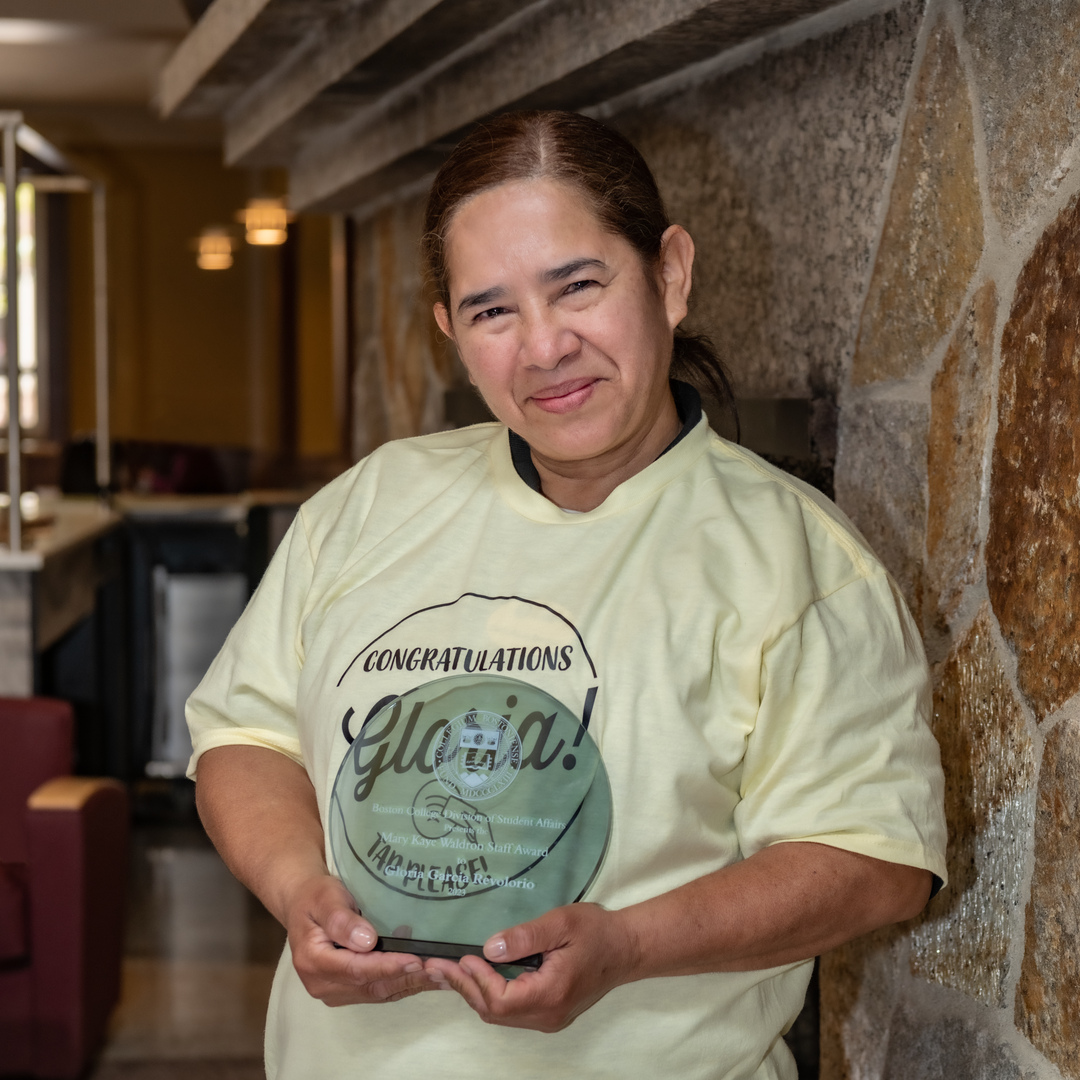 Ever to Excel Award Mary Kaye Waldron Staff Award: Gloria Garcia Revolorio - Cashier, Corcoran Commons surrounded by some of her colleagues in Dining Services. Taken in the kitchen of Corcoran Commons and in the dining hall itself.