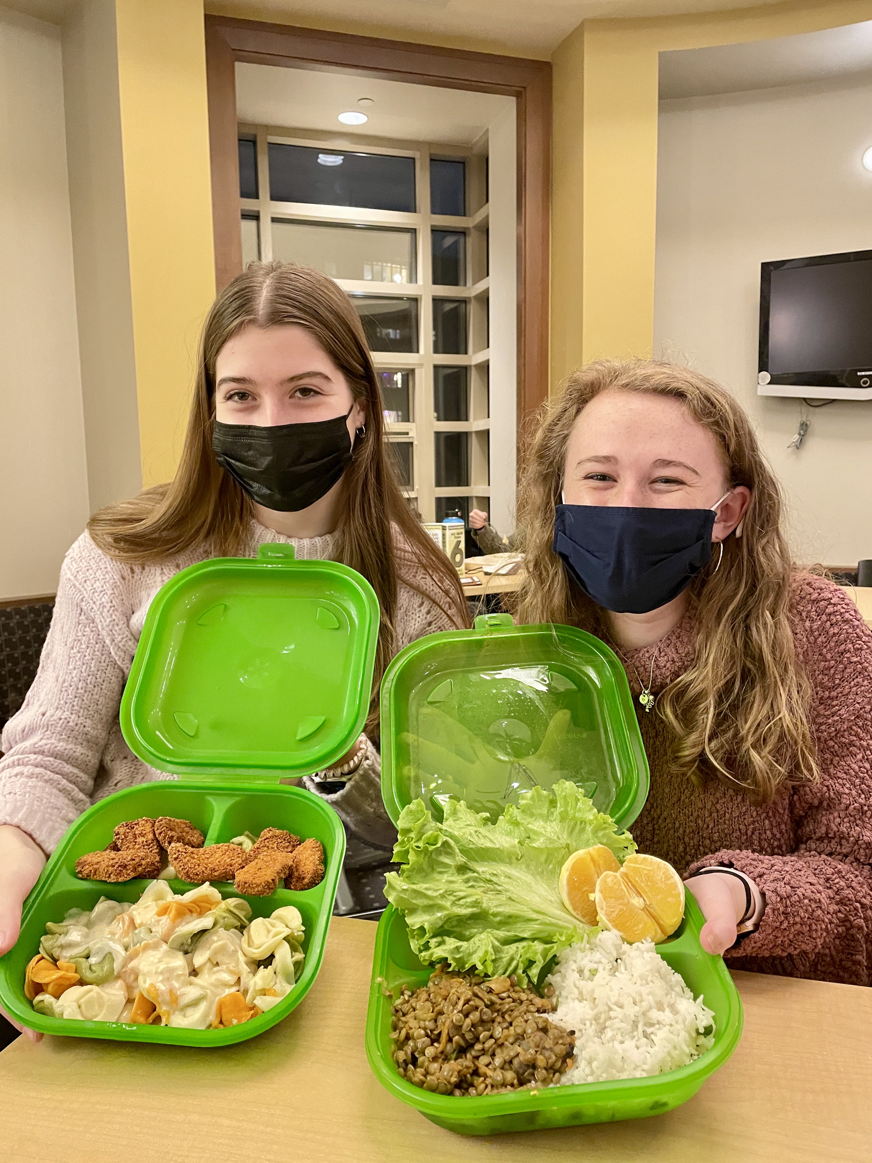 Students holding Green2Go containers
