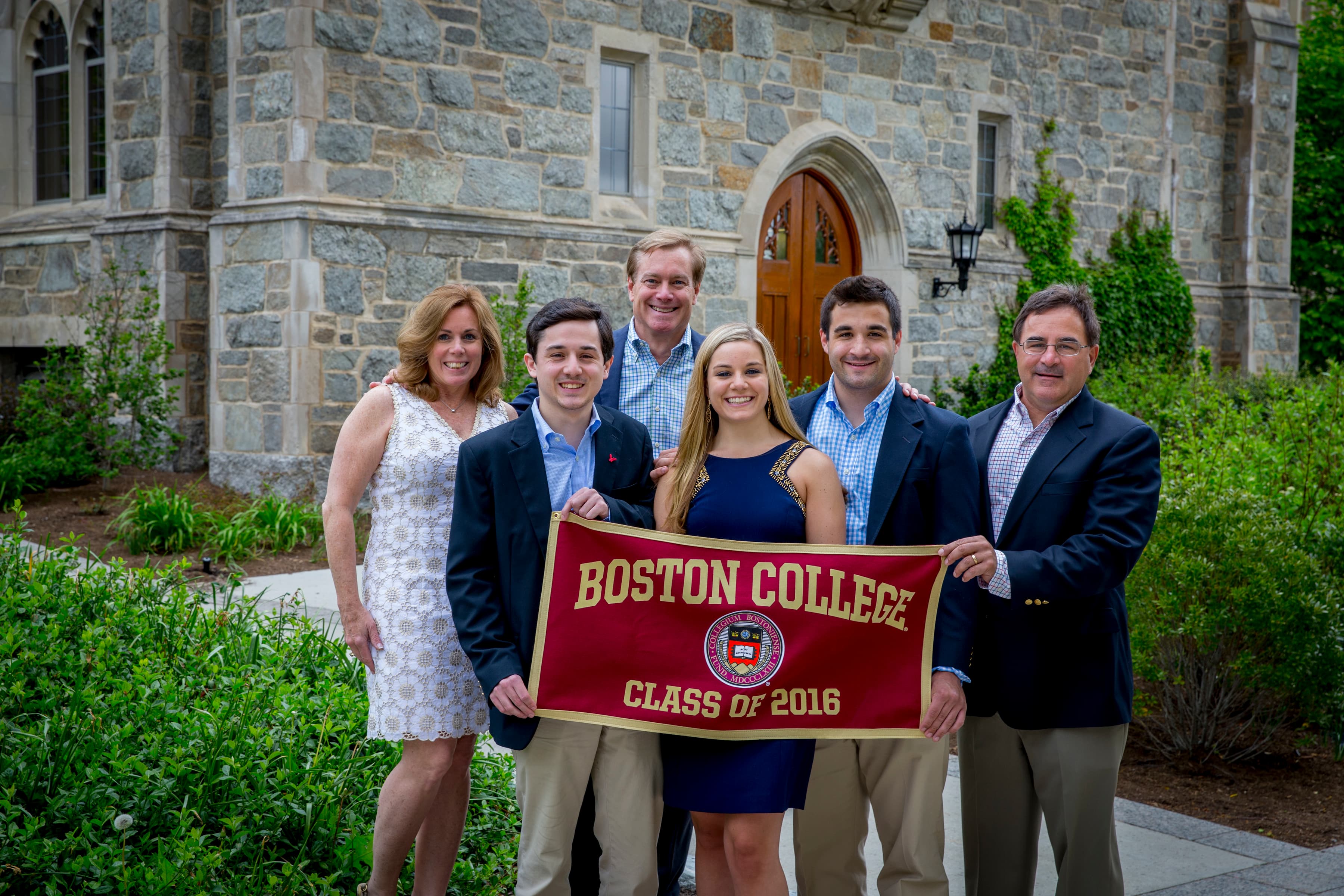 a family holding a Boston College class of 2016 sign