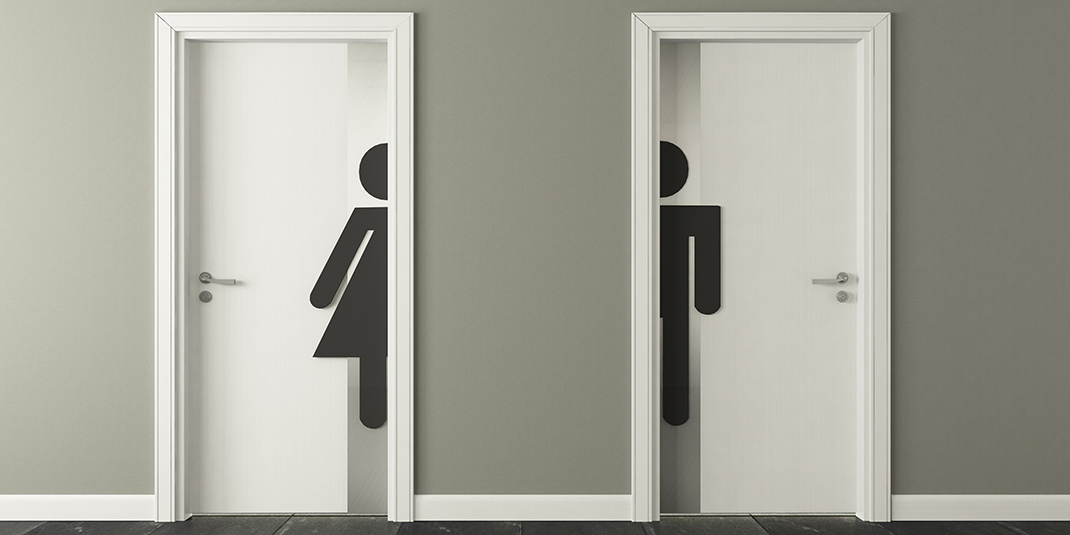 Doors with silhouettes of a person in a dress and a person in pants on them