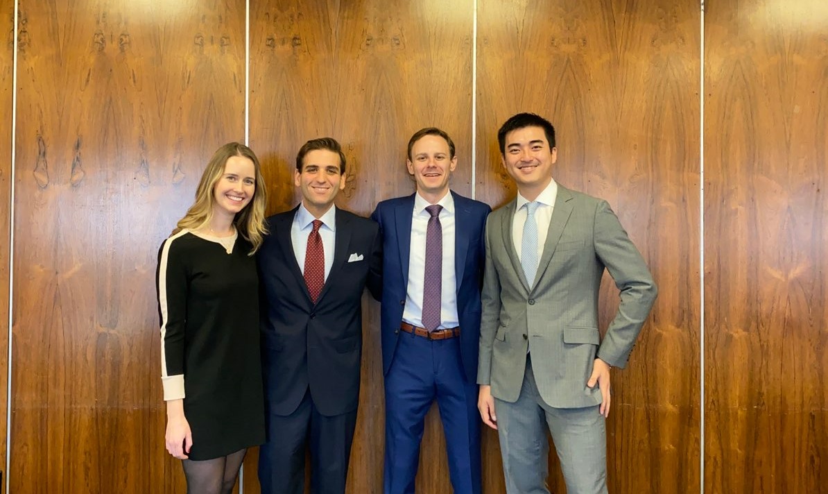 The winning team poses in a conference room