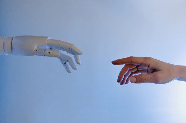 robot hand reaching towards a human hand