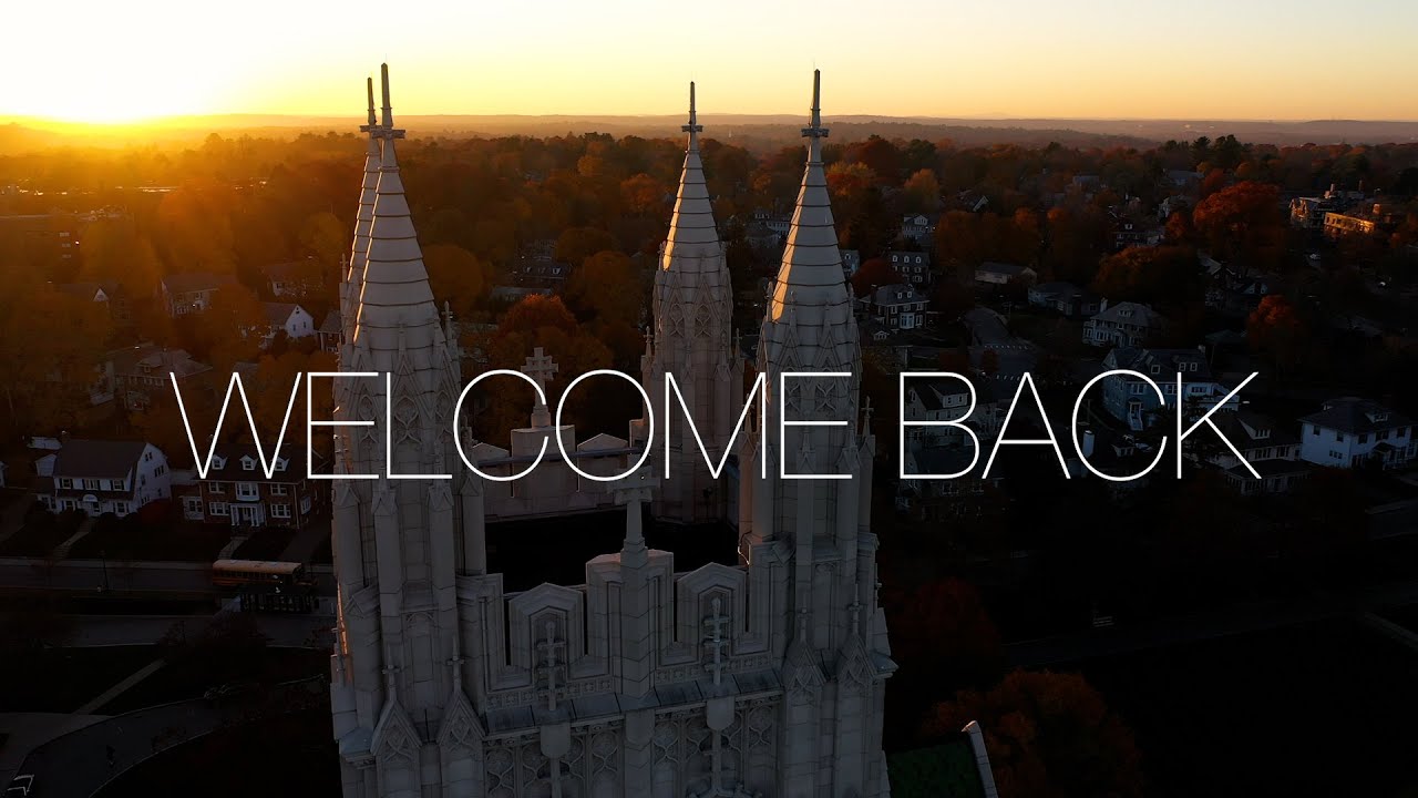Aerial photo of Gasson Hall at sunset with the words "Welcome Back" superimposed across it