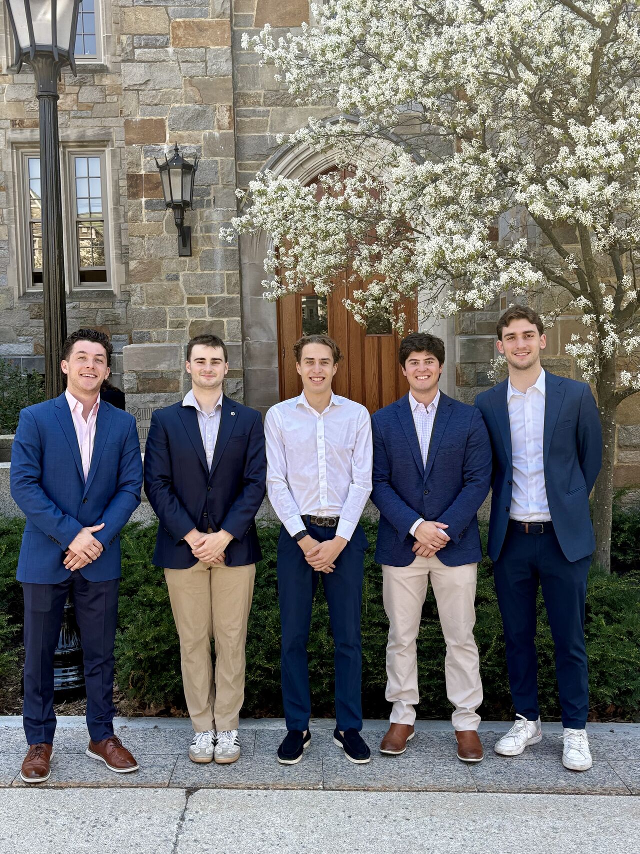 The five members of the Regatta Grove team stand outside a Boston College building.