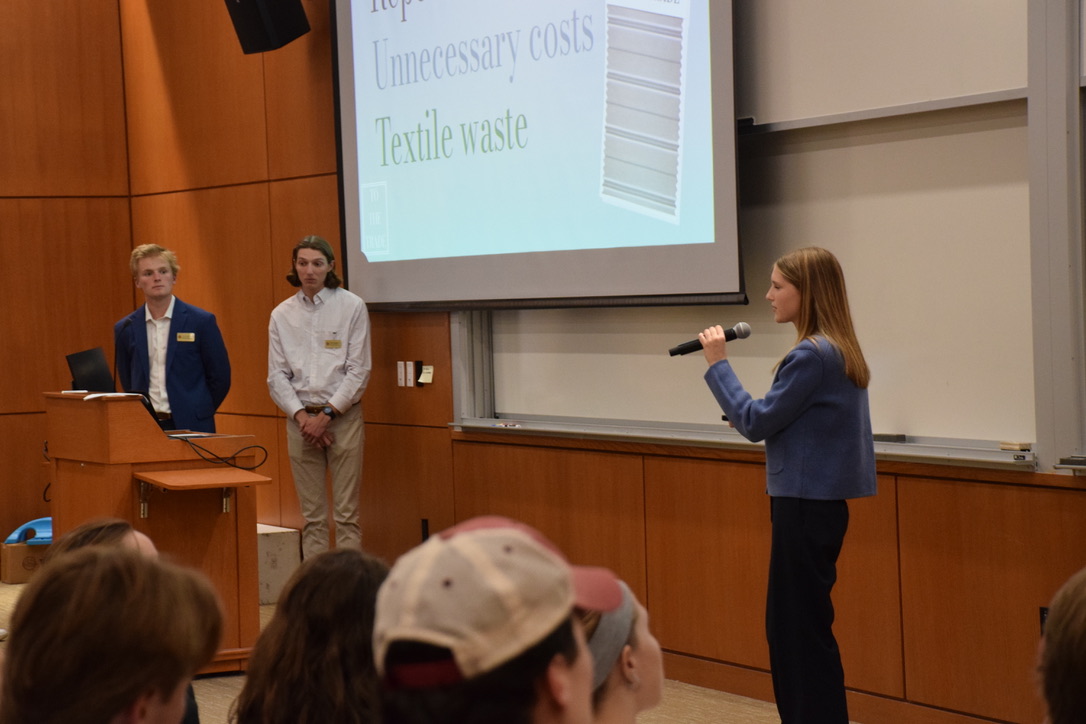 Emma Mooney stands at the front of a lecture hall and presents her pitch at the Strakosch Venture Competition.
