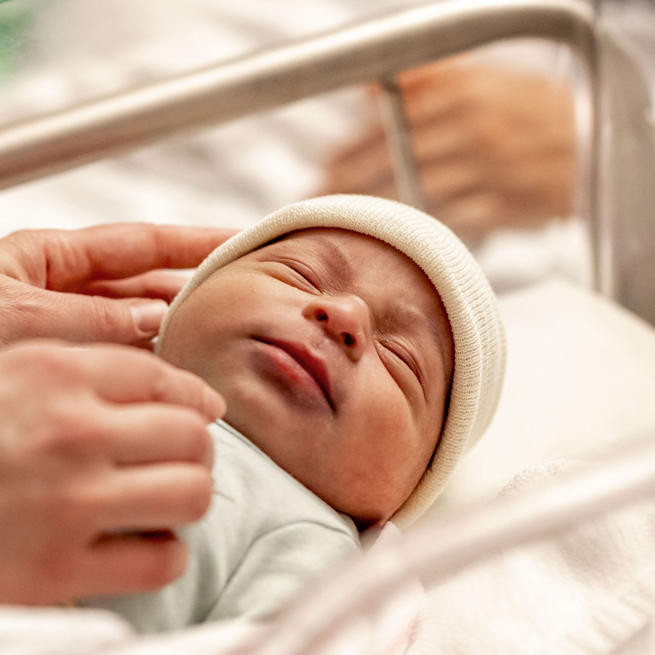 A newborn baby in hospital crib