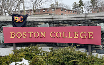 The Afro-Centric BC sweater hanging above a red Boston College sign.