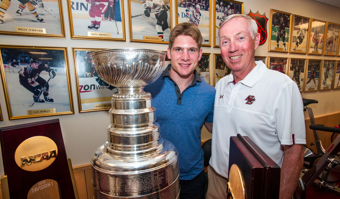 Ben Smith  ’10, M.Ed. ’20, and Jerry York, Boston College’s Schiller Family Head Hockey Coach, with the Stanley Cup in 2013. Smith was a member of the Chicago Blackhawks Stanley Cup championship team.