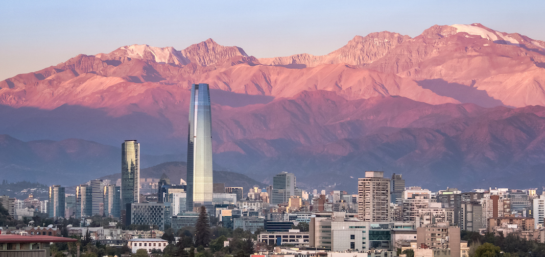 1095471704 Aaerial view of Santiago skyline at sunset with Costanera skyscraper and Andes Mountains - Santiago, Chile