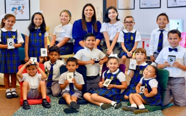 Crimsonbridge Foundation representative with students