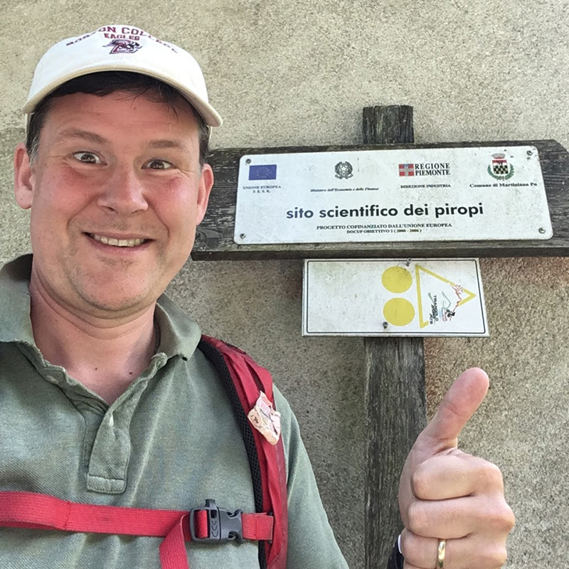 A man next to a sign