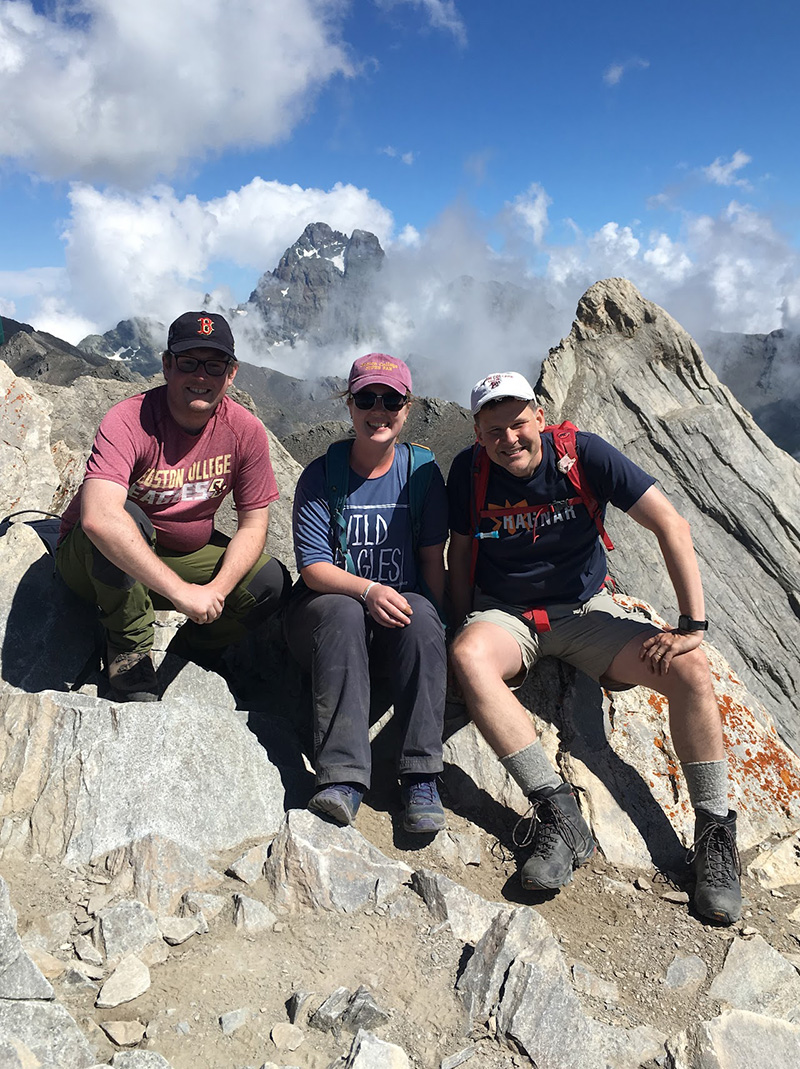 Three people on the side of a mountain