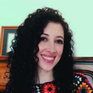 brunette person with long curly brown hair 