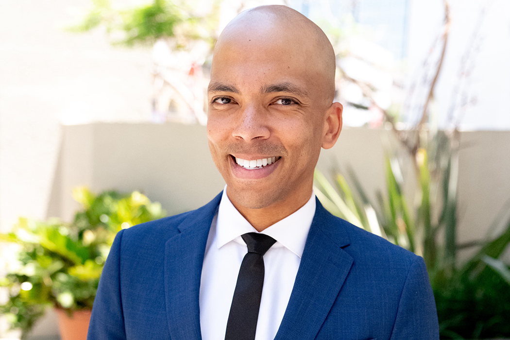 A photo of Christopher Baidoo in a blue suit and white shirt.