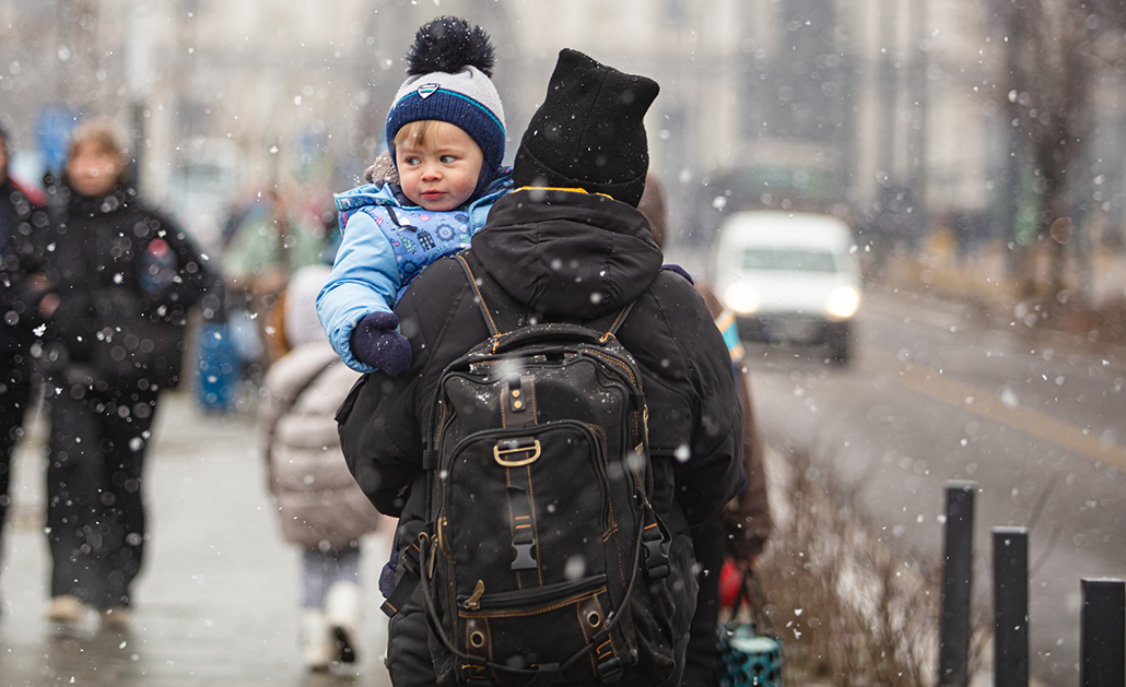 An adult holds a child in Ukraine