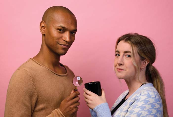 Photo of Griff Stark-Ennis ’14 and Ceara O’Sullivan ’14 holding a magnifying glass and a mug