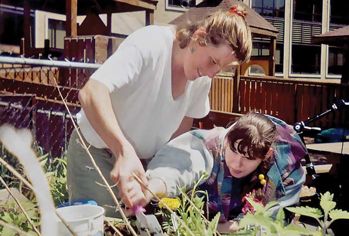 Teacher and student gardening
