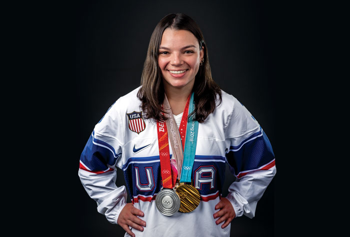 Cayla Barnes smiling with two Olympic medals