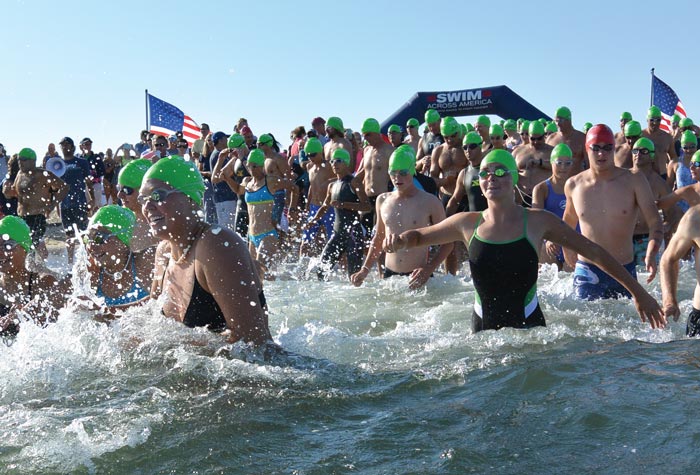 Swimmers running into the water 