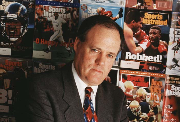 Mulvoy as photographed in front of a wall of Sports Illustrated magazine covers