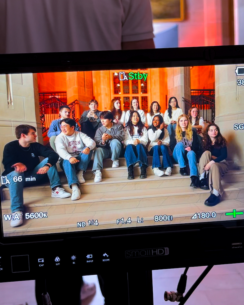view from the camera's viewfinder of the CommonTones singing on the stairs