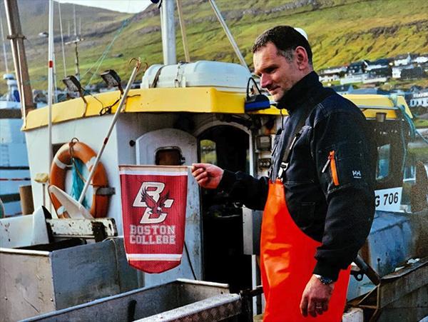 A fisherman holding a BC banner