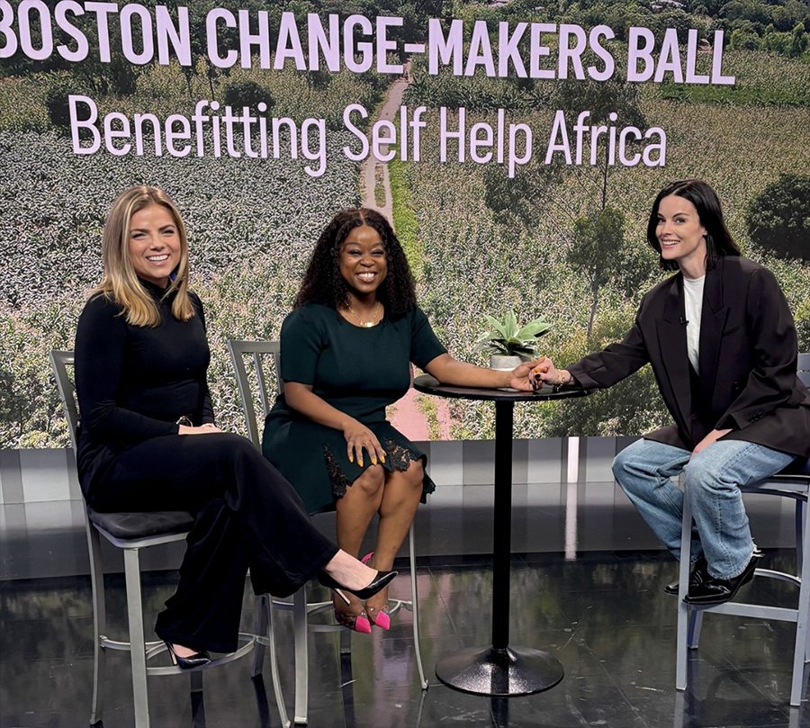 Three women sitting on a television set