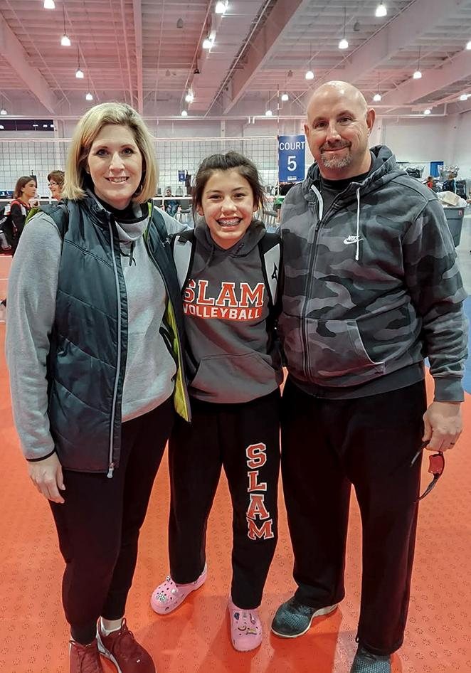 Three people standing in a gymnasium