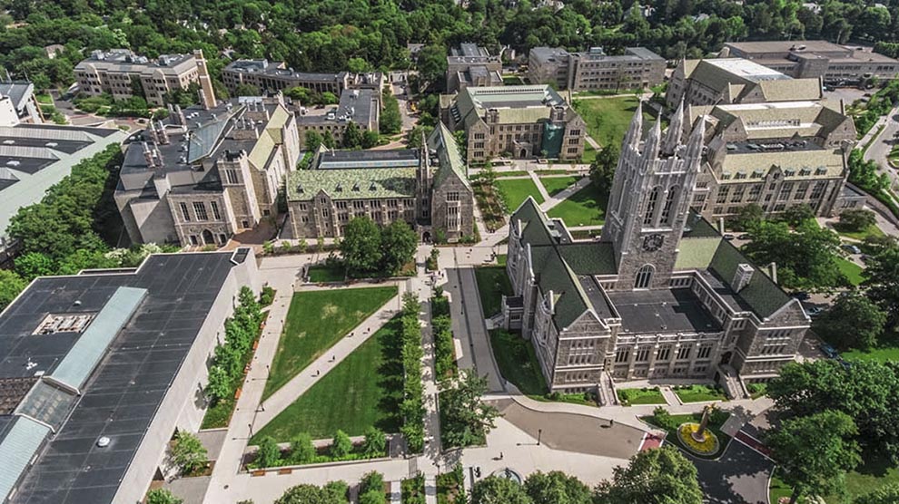 Aerial view of Boston College's campus with students crossing the quad