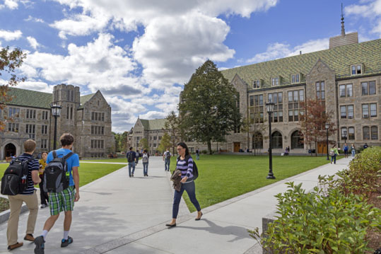 Students cross the quad in front of Fulton Hall